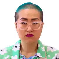 a woman wearing glasses and a green shirt with white flowers