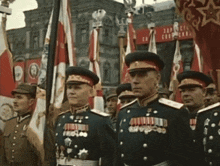 a group of men in military uniforms are standing in front of a sign that says ' apollo ' on it