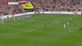 a man in a white shirt is jumping in the air during a cbs sports game