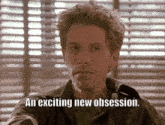 a man sitting in front of a window with the words an exciting new obsession above him