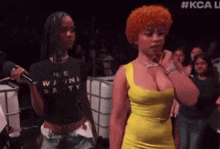 a woman in a yellow dress is standing next to a woman in a black shirt that says we wanna party
