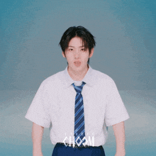 a young man wearing a white shirt and a blue tie with studio choom written on the front