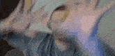 a blurry picture of a person 's face with their hands outstretched .