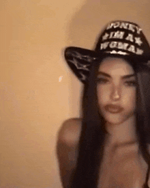 a woman wearing a hat that says `` honey , i 'm a woman '' .
