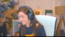 a woman wearing headphones with the letter c on the top