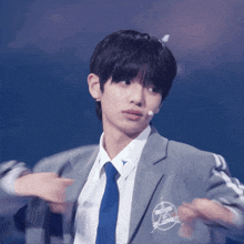 a young man in a suit and tie has a sticker on his jacket that says eos on it