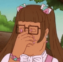 a cartoon girl is covering her face with her hand and wearing glasses .
