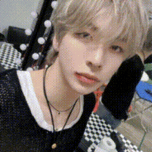 a young man is taking a selfie in a room with a microphone .