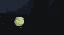 a yellow jellyfish is floating in the dark water