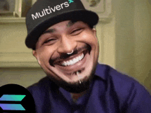 a man wearing a hat that says " multivers " is smiling