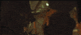 a group of people are standing in a dark room with a glowing object in the center