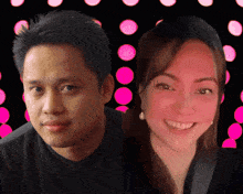 a man and a woman are posing for a picture with pink circles in the background
