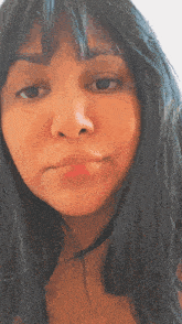 a close up of a woman 's face with dark hair