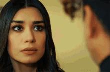 a woman looks at a man with a serious look on her face