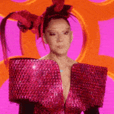 a woman wearing a red dress with sequins and a red headband
