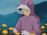 a girl in a purple jacket is picking yellow flowers