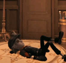 a cartoon character laying on the floor with a hat on