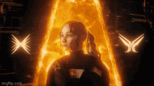 a woman is standing in front of a fire coming out of her chest