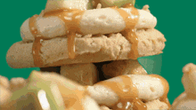 a close up of a stack of food with caramel sauce