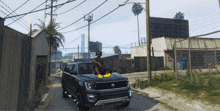 a man is sitting on the hood of a ford expedition