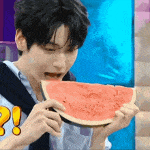 a young man is eating a slice of watermelon with an exclamation point on it