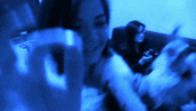 a blurry picture of a woman holding a glass of wine