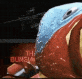 a close up of a red and blue object with the words the bungie on it