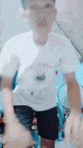 a man wearing a white t-shirt that says " i love you " on it