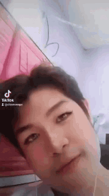 a close up of a man 's face with a tiktok watermark on the bottom