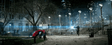 a man in a suit stands in a park at night