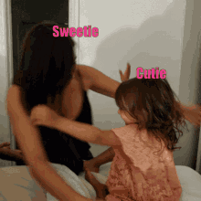 a woman is hugging a little girl with the words sweetie and cutie written in pink