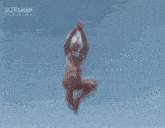 a monster is flying through the air with fire coming out of it 's mouth .