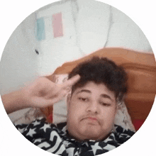 a man is laying on a bed with his hand on his head