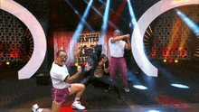 a group of wrestlers pose in front of a poster that says the most wanted