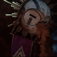 a purple flag with an a on it is hanging next to a statue