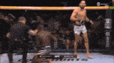 a man in a boxing ring with the words ufc hurts on the ground