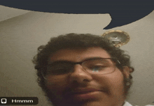 a man wearing glasses has a speech bubble above his head that reads hmm