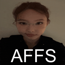 a woman wearing glasses is standing in front of a poster that says affs