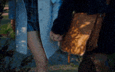 a woman in a white coat holds the hand of another woman in a plaid skirt
