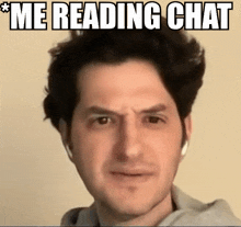 a man is wearing headphones and making a funny face with the caption " me reading chat " above him