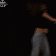 a blurry picture of a woman holding a purple light saber in the dark