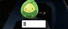 a green cartoon character with the letter b on it