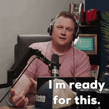 a man wearing headphones says " i 'm ready for this " while sitting in front of a microphone