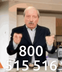 a man in a suit stands in front of a table with a glass of coffee and the number 800 on it