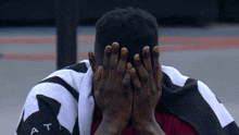 a person covering their face with a towel that says at