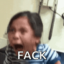 a little girl is crying with the word fack written on her face