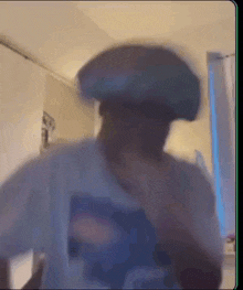 a blurry picture of a man wearing a hat .