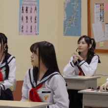 a girl in a sailor uniform has a name tag that says lily