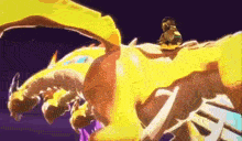 a cartoon character is riding on the back of a large yellow dragon .