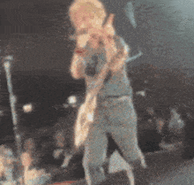 a blurry picture of a man playing a guitar on stage